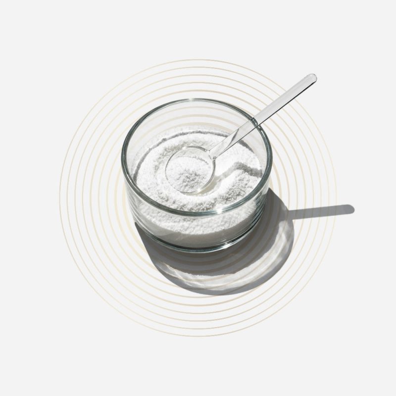 Glass of beetroot supplement powder with spoon for health benefits.